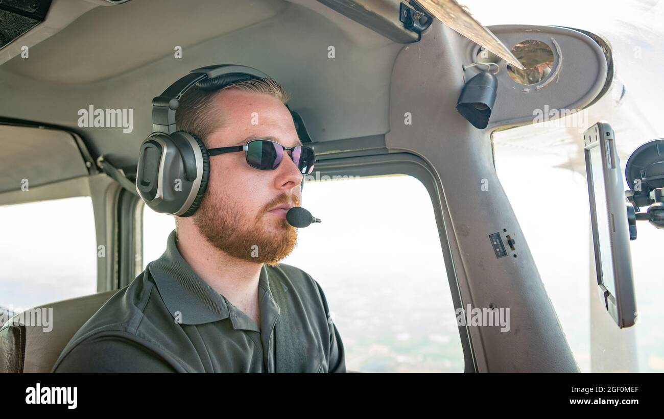 Airplane pilot focuses on flight in the cockpit Stock Photo Alamy