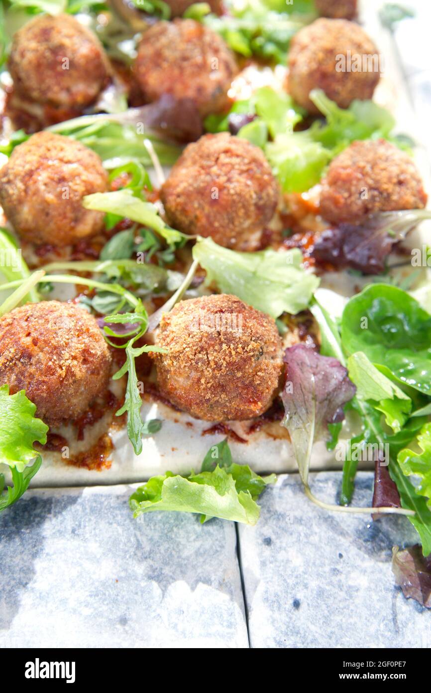 Second dish of meatballs and green salad Stock Photo