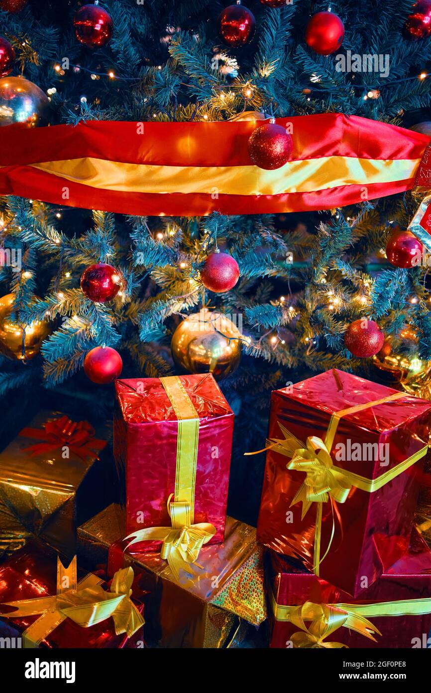 Gifts under Christmas tree. New year's surprises. Red-wrapped boxes