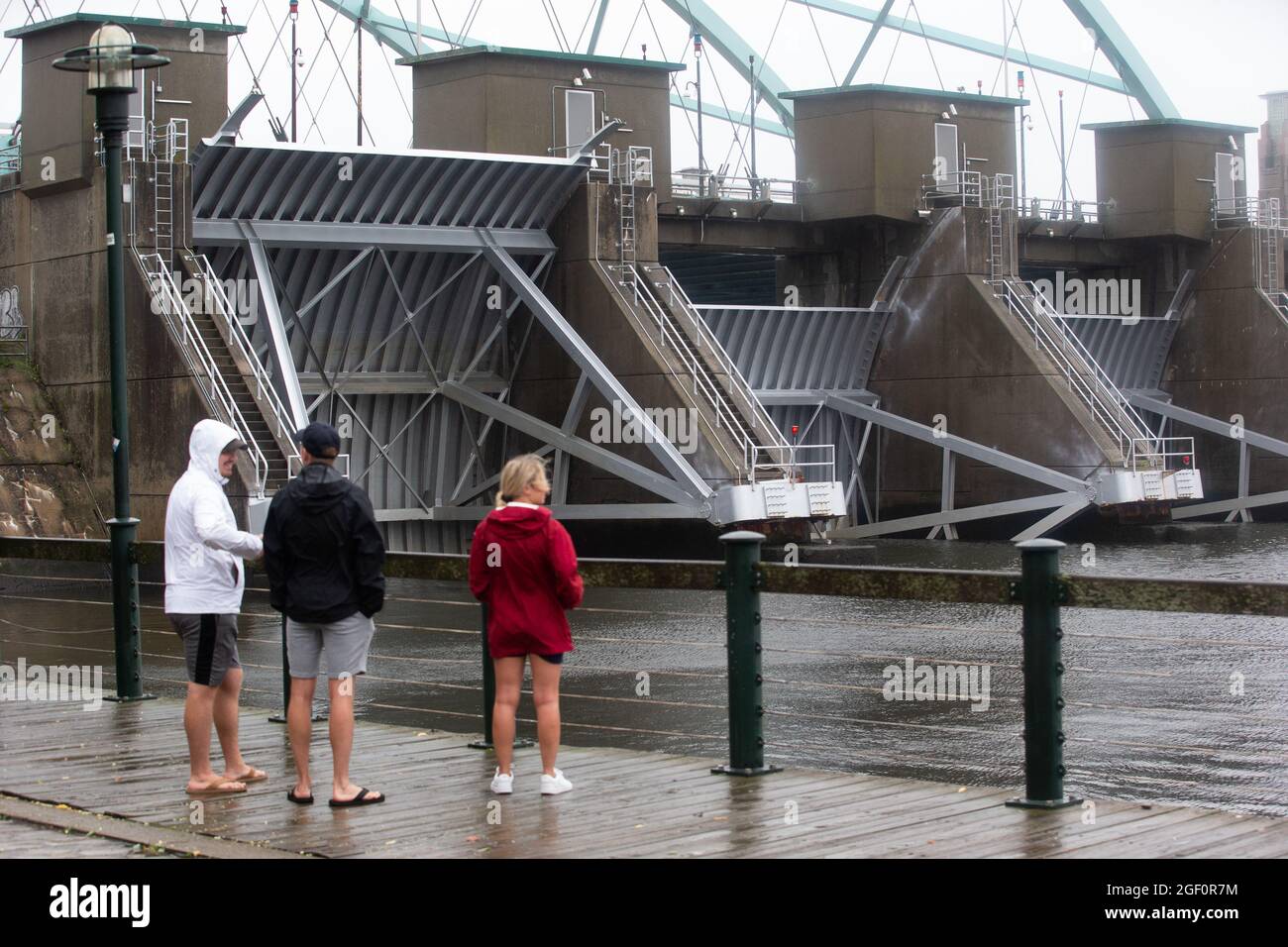 Cranston, United States. 22nd Aug, 2021. People stop to look at the lowered gates of the Fox Point Hurricane Barrier as Tropical Storm Henri arrives in Providence, Rhode Island on Sunday, August 22, 2020. Tropical Storm Henri is expected to cause flooding and power outages across Connecticut and Rhode Island. Photo by Matthew Healey/UPI Credit: UPI/Alamy Live News Stock Photo