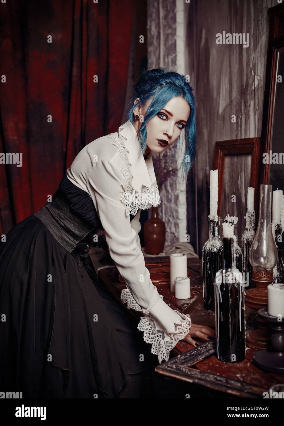 https://c8.alamy.com/comp/2GF0W2W/indoors-portrait-of-gorgeous-goth-girl-in-black-skirt-and-white-shirt-blue-haired-gothic-lady-vintage-look-2GF0W2W.jpg