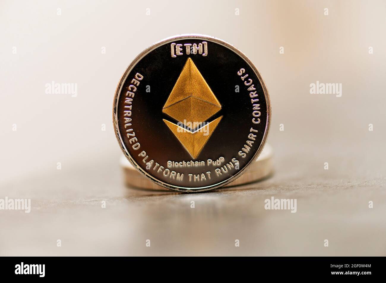Golden Etherium coin close up. Ether is a cryptocurrency whose blockchain  is generated by the Ethereum platform Stock Photo - Alamy