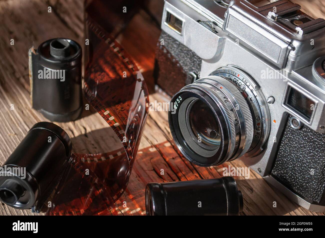 still life with retro camera, camera roll and cassettes on wood background Stock Photo