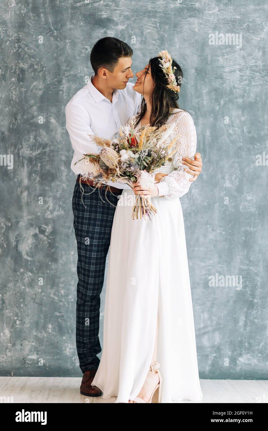 Wedding photo session of newlyweds in studio Happy young couple