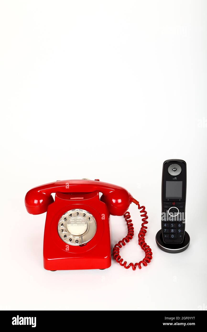 New BT advanced digital home phone using broadband connection to make HD quality telephone calls next to an old vintage GPO model 746F circa 1970s. Stock Photo