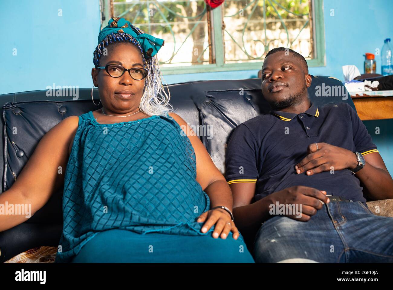 portrait of a beautiful happy african couple are sitting comfortably in ...