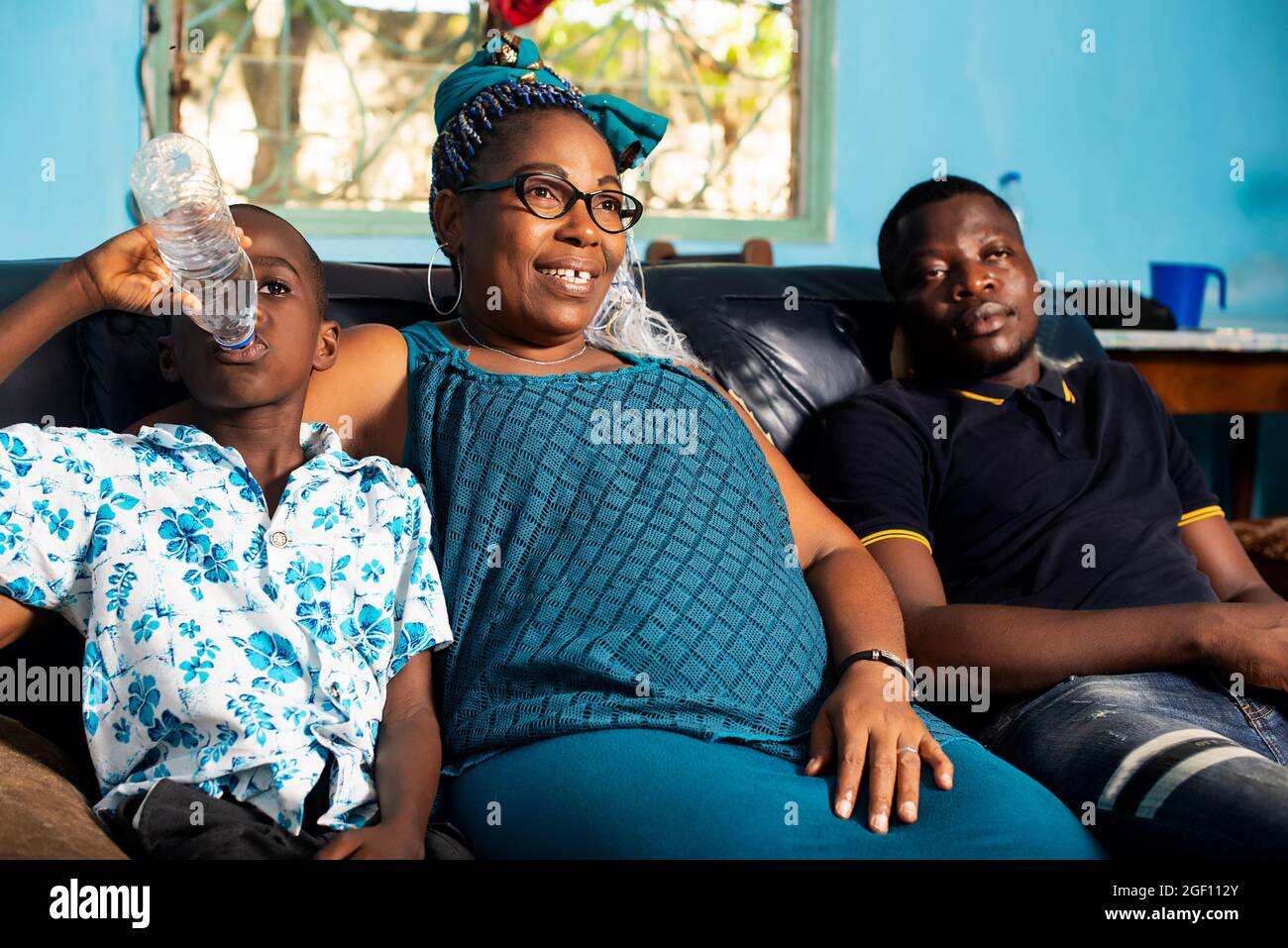 portrait of a beautiful African family sitting comfortably together on ...