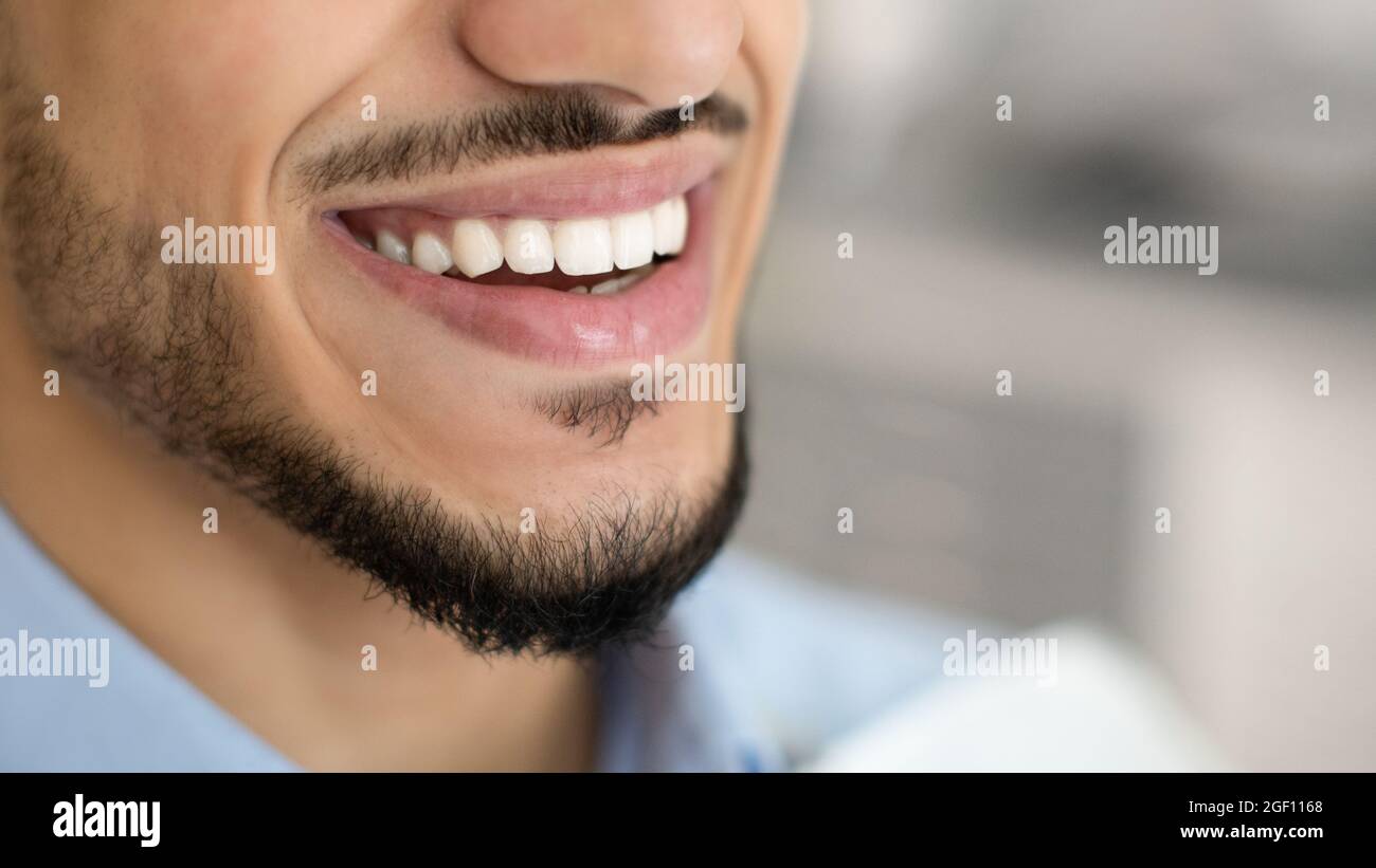 Dentistry Concept. Closeup Of Happy Young Middle-Eastern Man Smiling With Perfect Teeth Stock Photo