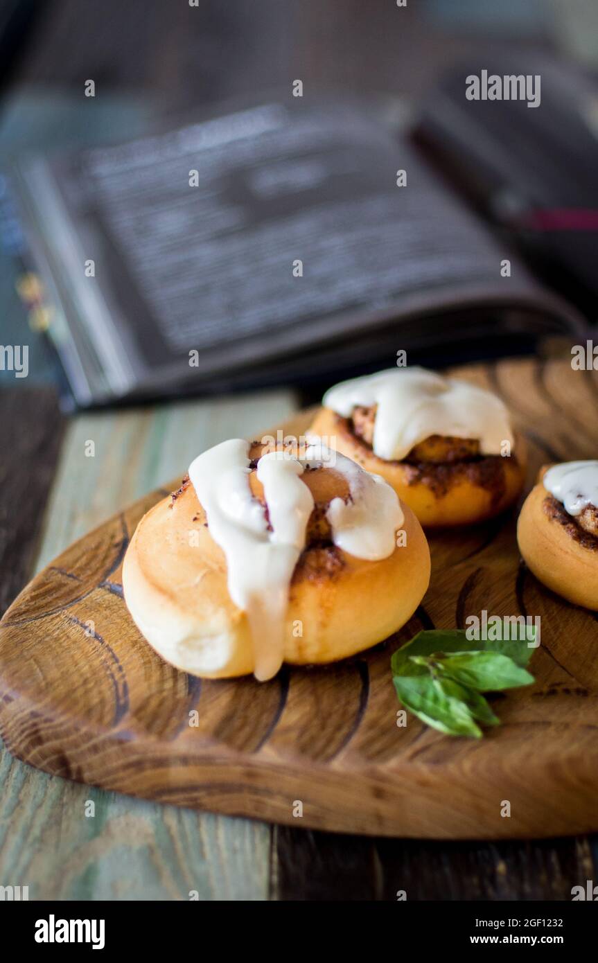 Homemade cinnamon buns and recipe book Stock Photo Alamy