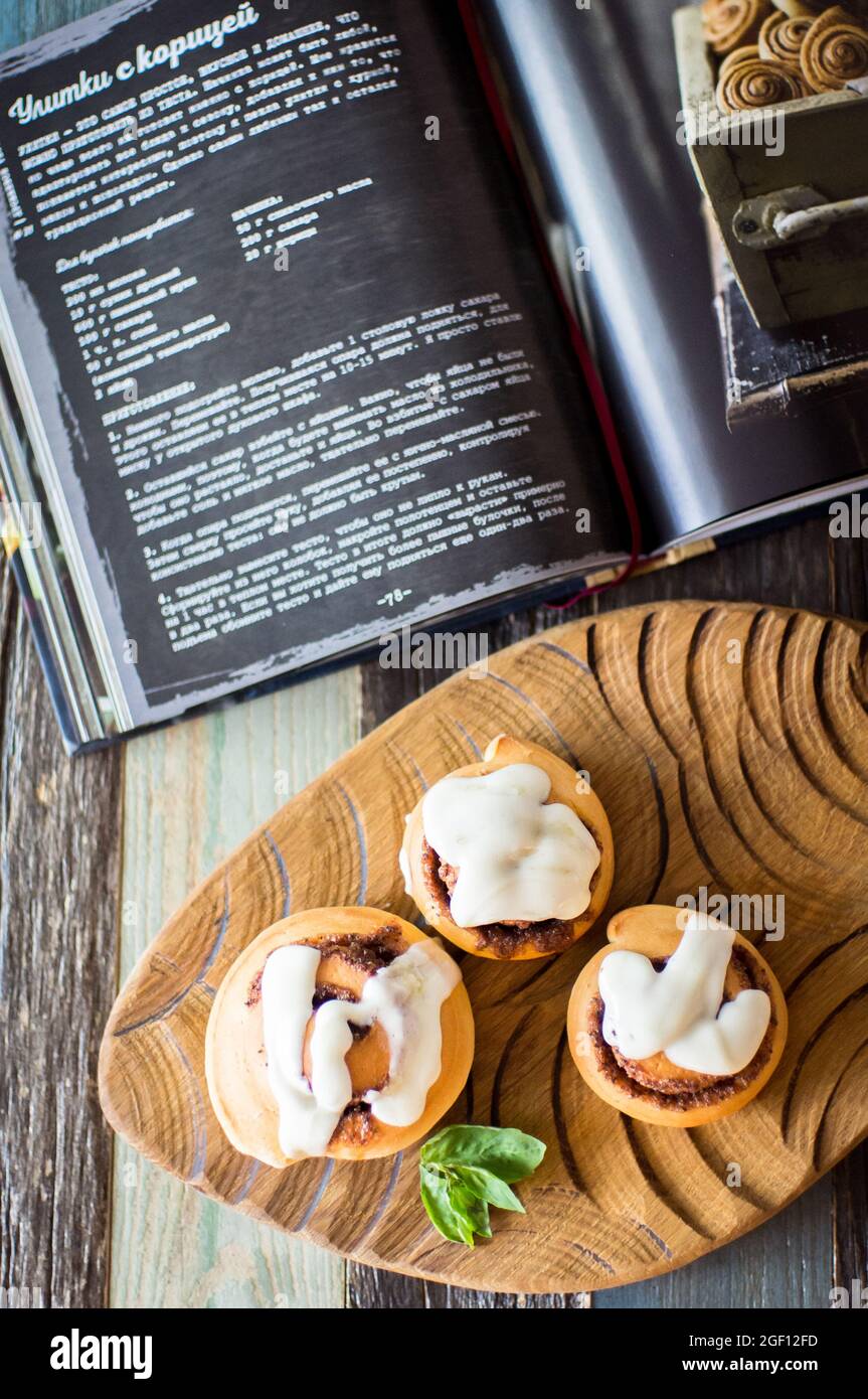 Homemade cinnamon buns and recipe book Stock Photo Alamy