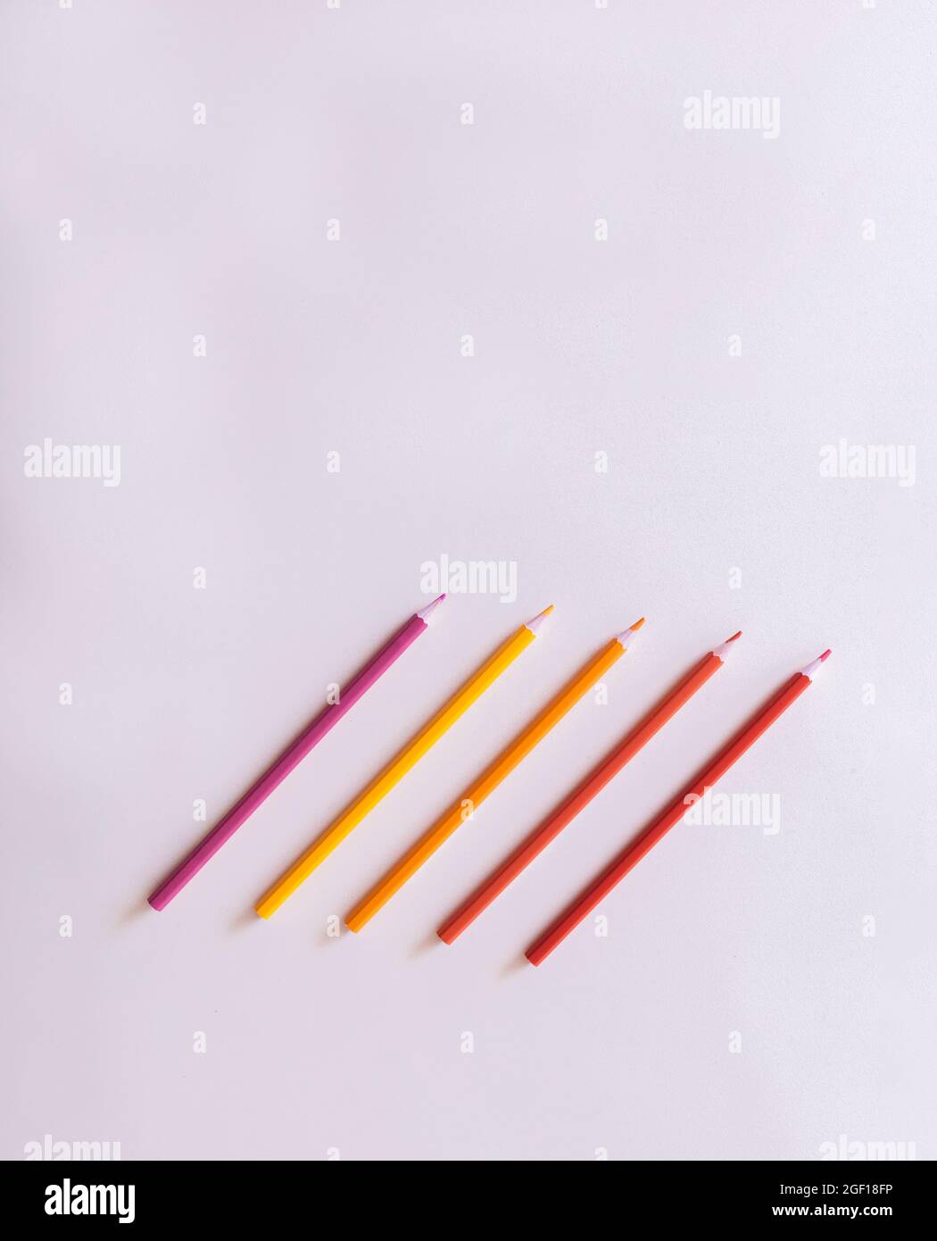 composition of colored pencils with red and yellow tones lined up on a