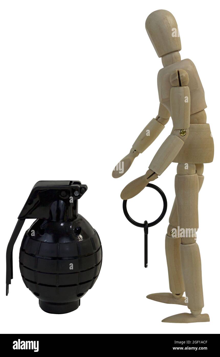 Pulling the pin from a grenade in preparation to throw it Stock Photo