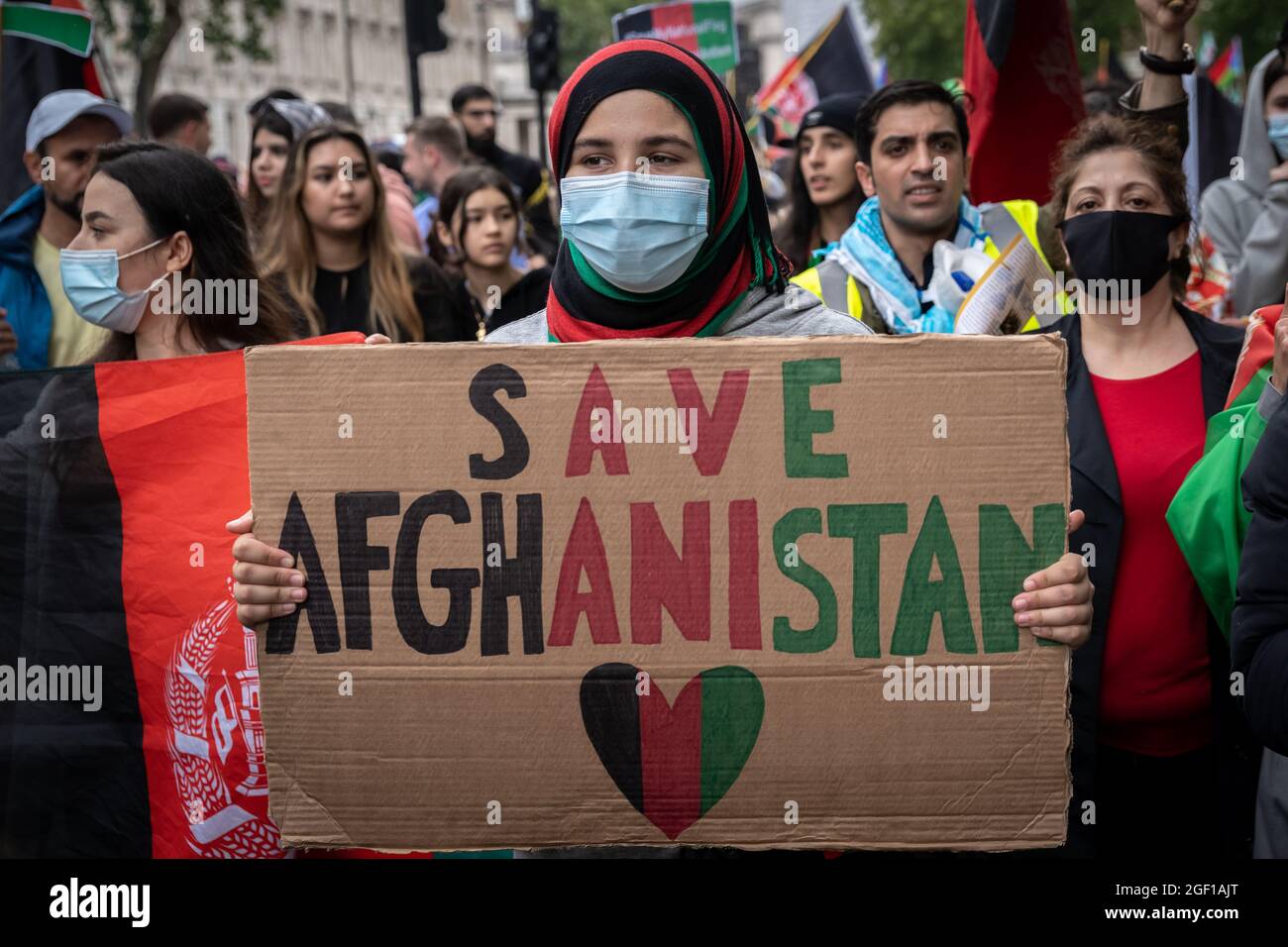 London, UK. 21st August, 2021. 'Stop Killing Afghans' mass protest march. Thousands of British-Afghans march from Marble Arch to Westminster in protest at the recent Taliban power grab of all major cities in Afghanistan. The protesters, many of them women, held placards reading “Stop the oppression of Afghan women”, “Afghanistan is bleeding” and “US & NATO failed”. Protesters were joined by people from Iran and Iraq who showed solidarity for the people in Afghanistan. Credit: Guy Corbishley/Alamy Live News Stock Photo