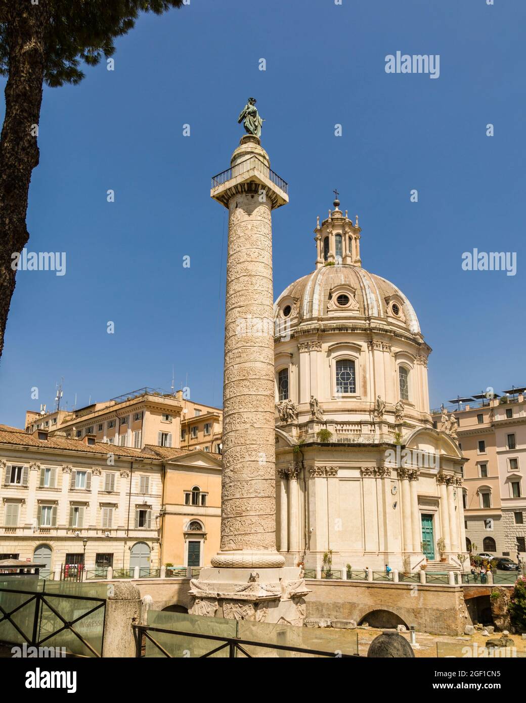 Trajan's Column, with The Church of the Most Holy Name of Mary in the background, Rome, Italy Stock Photo