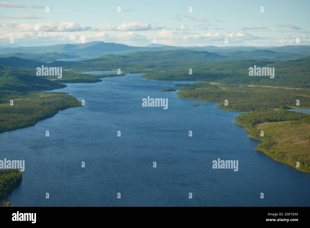 Aeriel view to Kiruna wilderness from helicopter with large lake  in the middle of the forest in far north of Swedish Lapland with higher peaks in the Stock Photo