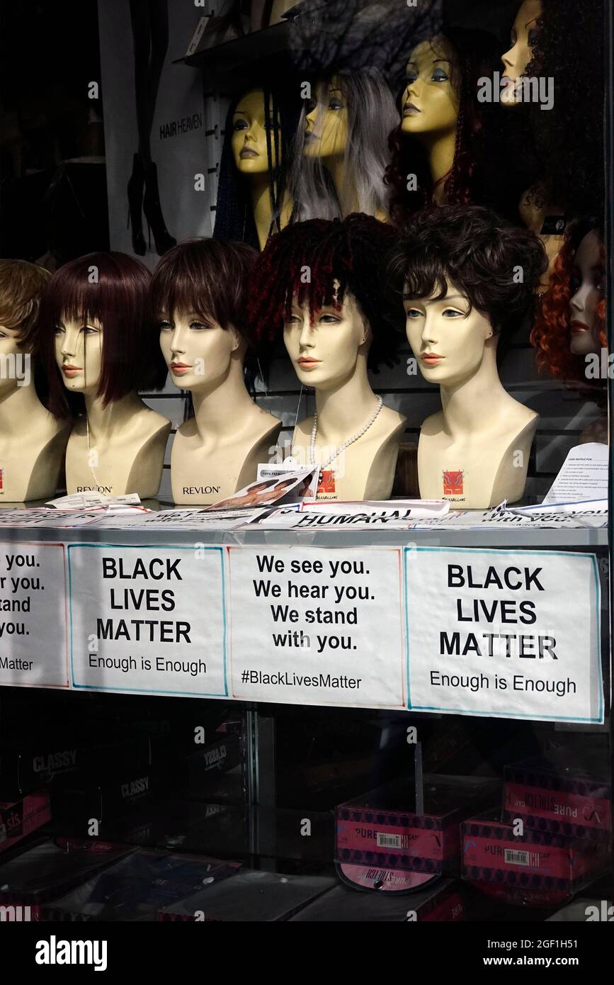 Black lives matter sign in front window of a wig store in Brooklyn NYC Stock Photo