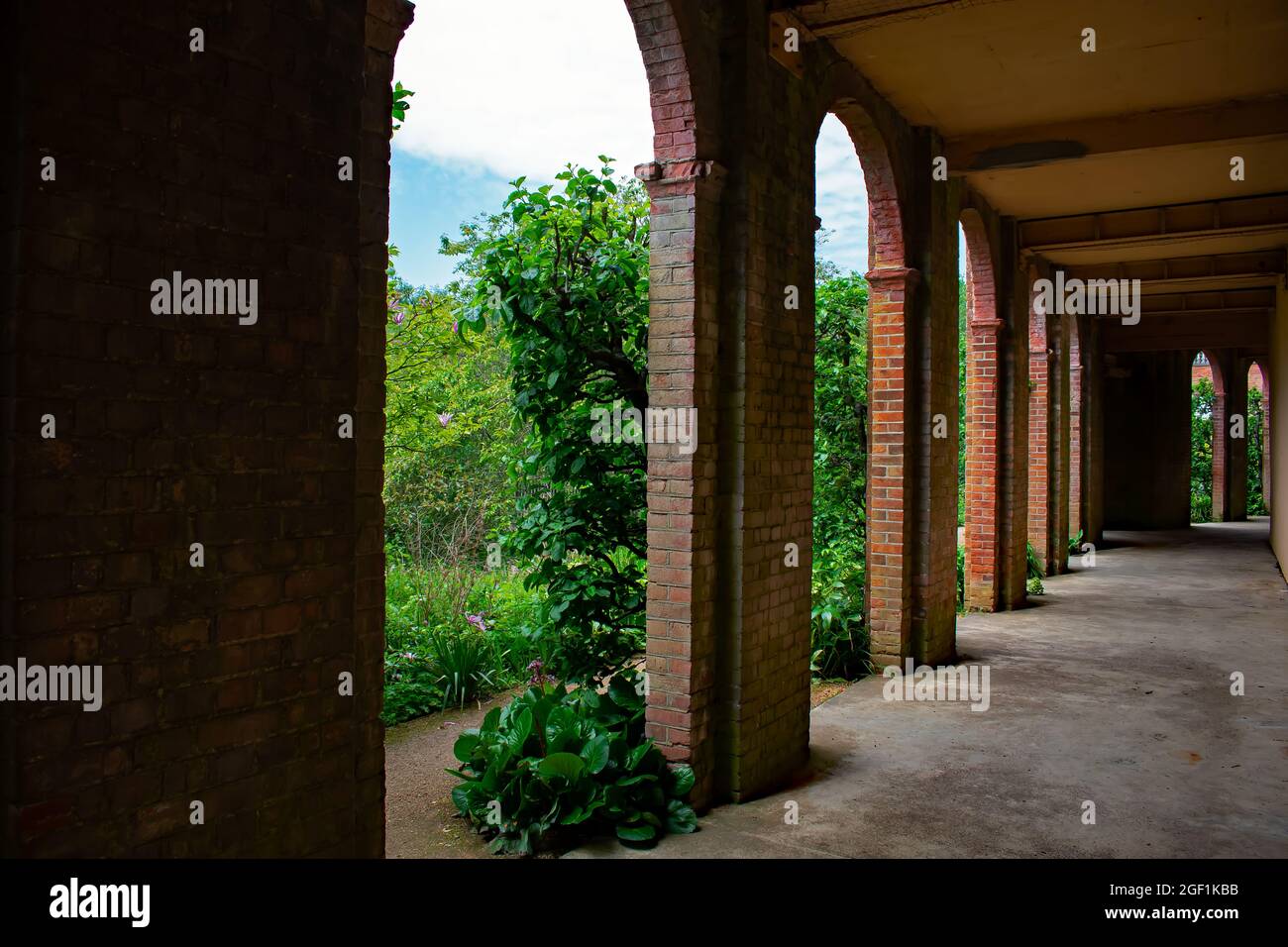 Standing under the brick terrace walkways at The Hill Garden and Pergola, Hampstead Heath, London, UK Stock Photo
