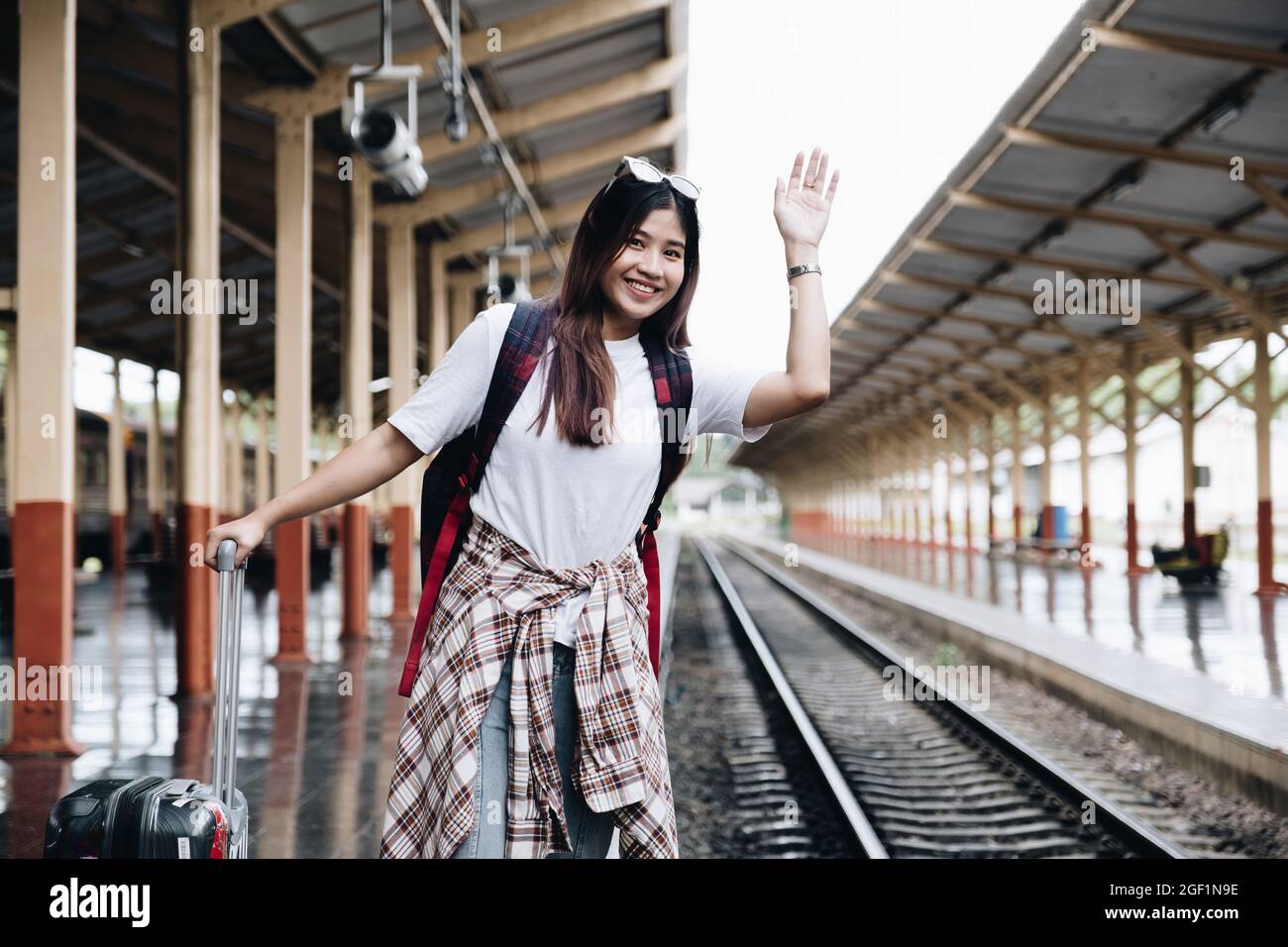 Image of A traveler looking for her friend for travel together. travel concept Stock Photo