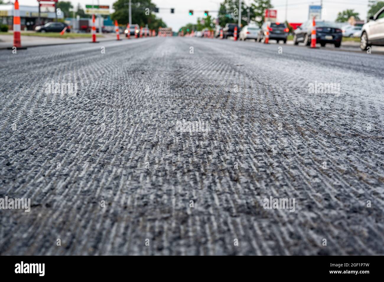 Low angle shot across a scarified street under construction with lanes on either side blocked off. Stock Photo