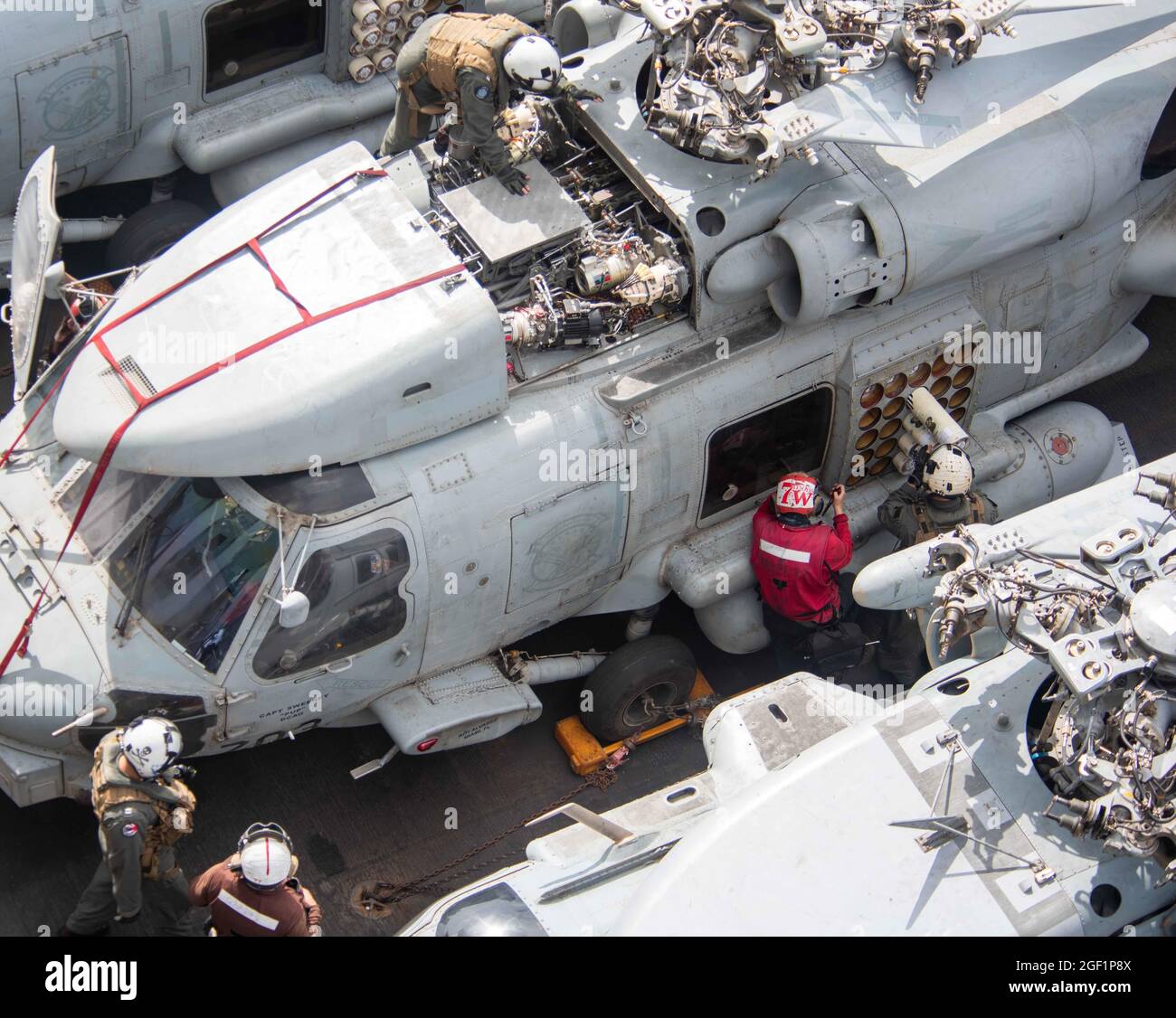 210822-N-UF592-1066 ARABIAN SEA (Aug. 22, 2021) – Sailors perform systems checks on an MH-60R Sea Hawk helicopter, attached to the “Saberhawks” of Helicopter Maritime Strike Squadron (HSM) 77, on the flight deck of aircraft carrier USS Ronald Reagan (CVN 76) in the Arabian Sea, Aug. 22. Ronald Reagan is the flagship for Carrier Strike Group 5 and is deployed to the U.S. 5th Fleet area of operations in support of naval operations to ensure maritime stability and security in the Central Region, connecting the Mediterranean and the Pacific through the western Indian Ocean and three strategic chok Stock Photo