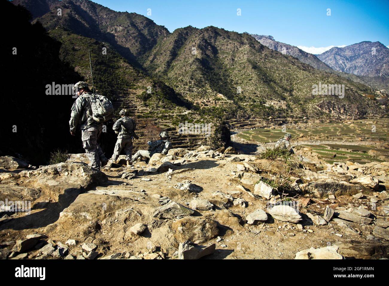 U.S. Army Soldiers assigned to Combat Company, 1st Battalion, 32nd Infantry Regiment, 3rd Brigade Combat Team, 10th Mountain Division, walk down to the Shigal Valley toward the village of Lachey in the Shigal district of Kunar province, Afghanistan on Dec. 7. Stock Photo