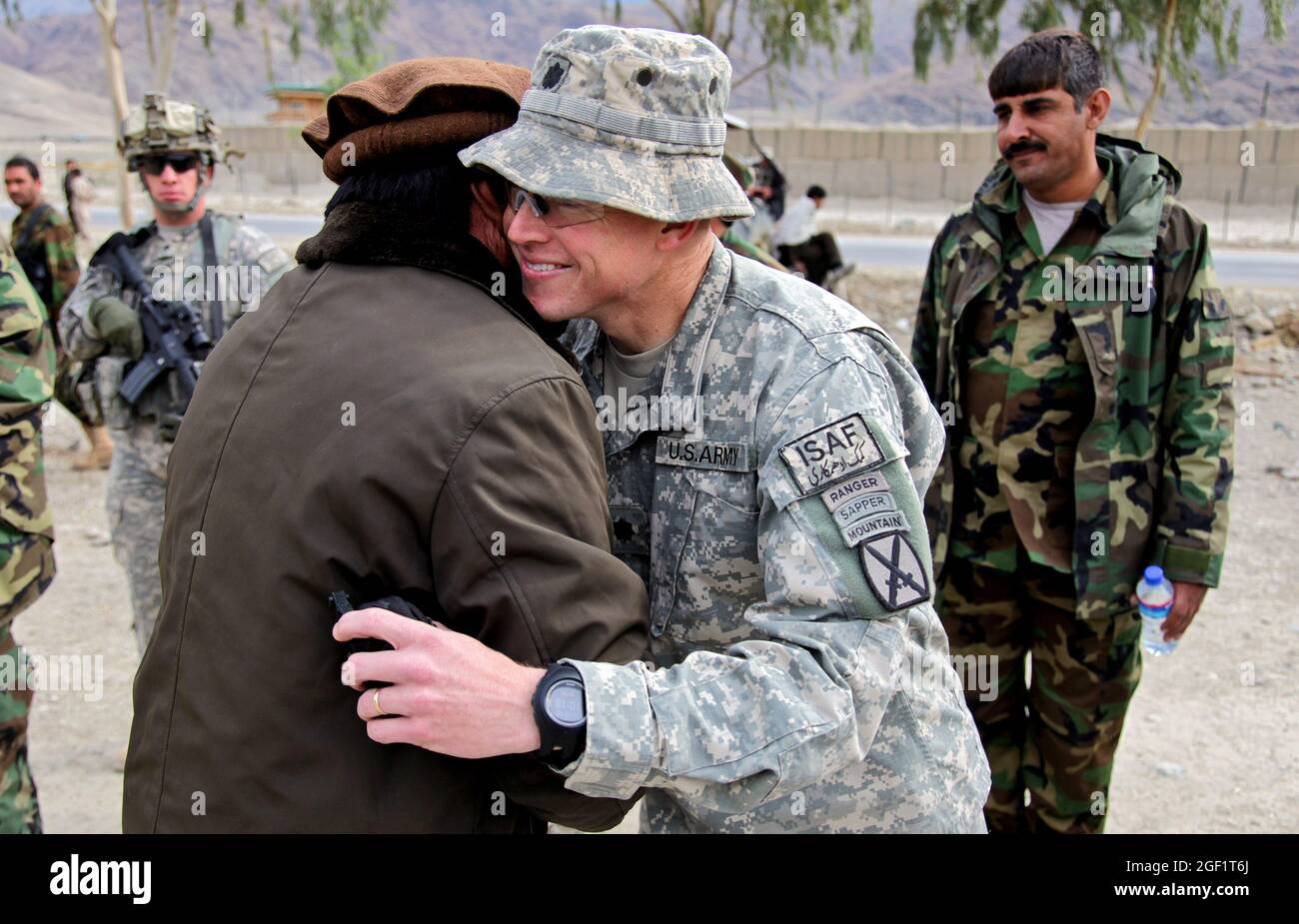 U.S. Army Lt. Col. Frederick O'Donnell, Commander of 1st Battalion, 32nd Infantry Regiment, 3rd Brigade Combat Team, 10th Mountain Division, greets Hamish Gulab, the Sarkani District governor, before a ground breaking ceremony for the Ghulam Mohammad Sports Complex in the Sarkani District of Kunar province, Afghanistan, Dec. 12, 2009. Stock Photo