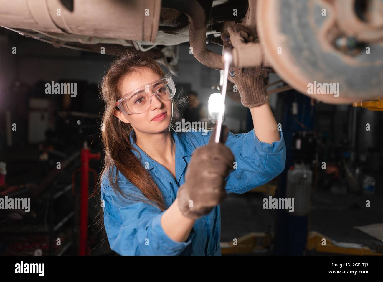 Mechanic working under the hood at the repair garage Stock Photo