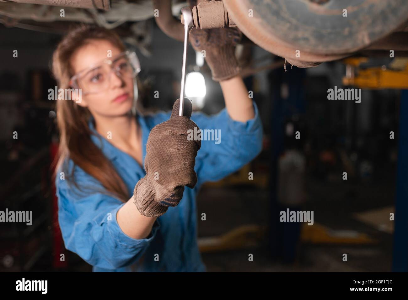Mechanic working under the hood at the repair garage Stock Photo