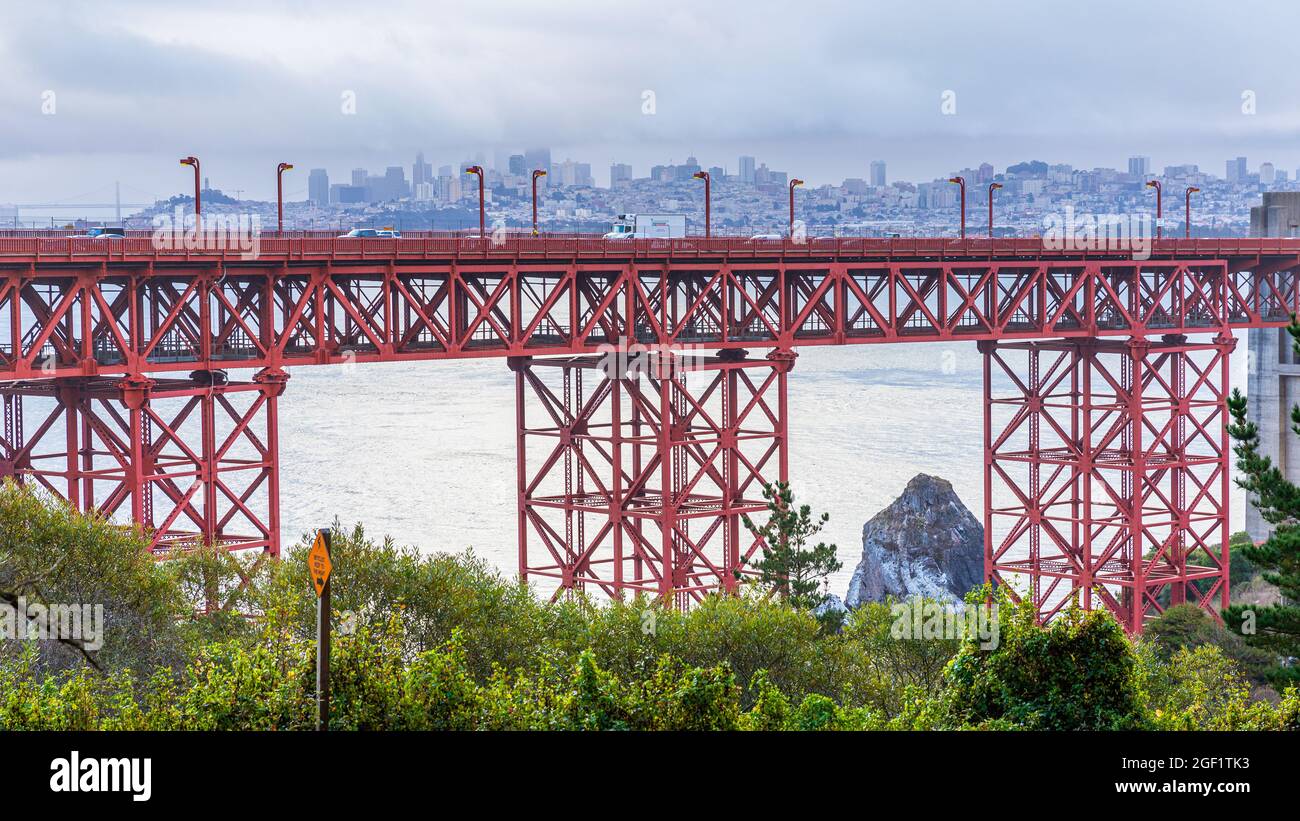 Aerial view over road of Golden Gate bridge with blurry background of San Francisco, California, USA. Stock Photo