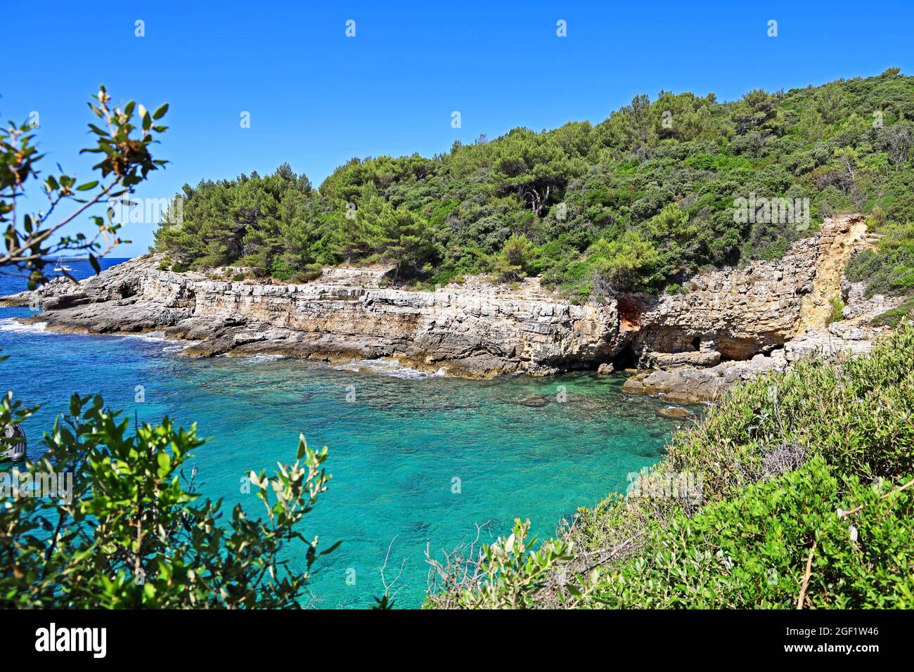beautiful bay in croatia on the adriatic sea with stone cliffs and turquoise blue water Stock Photo