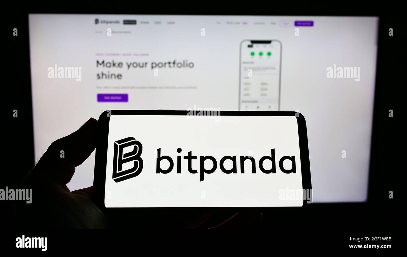 Person holding cellphone with logo of Austrian crypto exchange company  Bitpanda GmbH on screen in front of business webpage. Focus on phone  display Stock Photo - Alamy