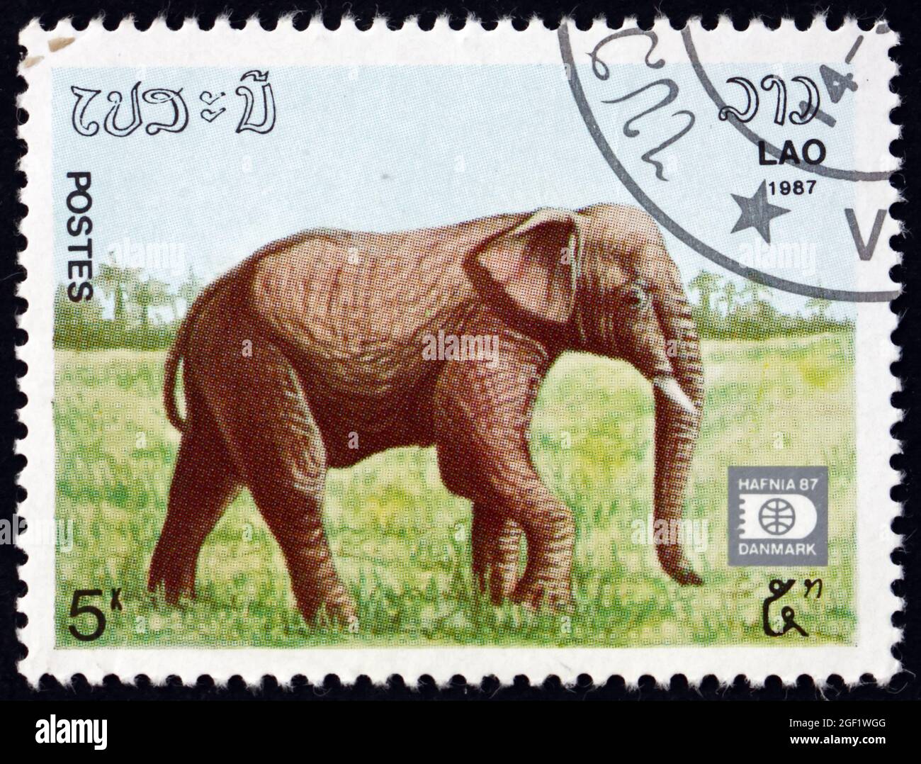 LAOS - CIRCA 1987: a stamp printed in Laos shows Indian elephant ...