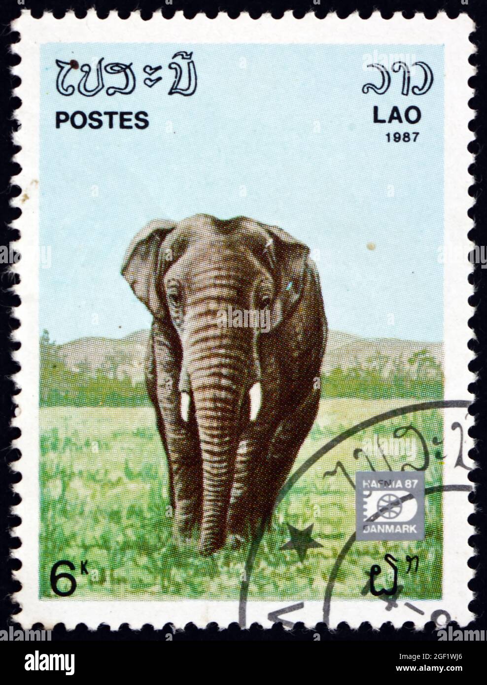 LAOS - CIRCA 1987: a stamp printed in Laos shows Indian elephant ...