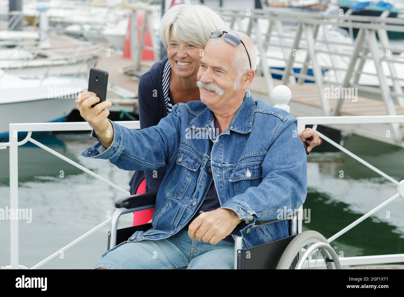 a senior couple in wheelchair doing a selfie Stock Photo - Alamy