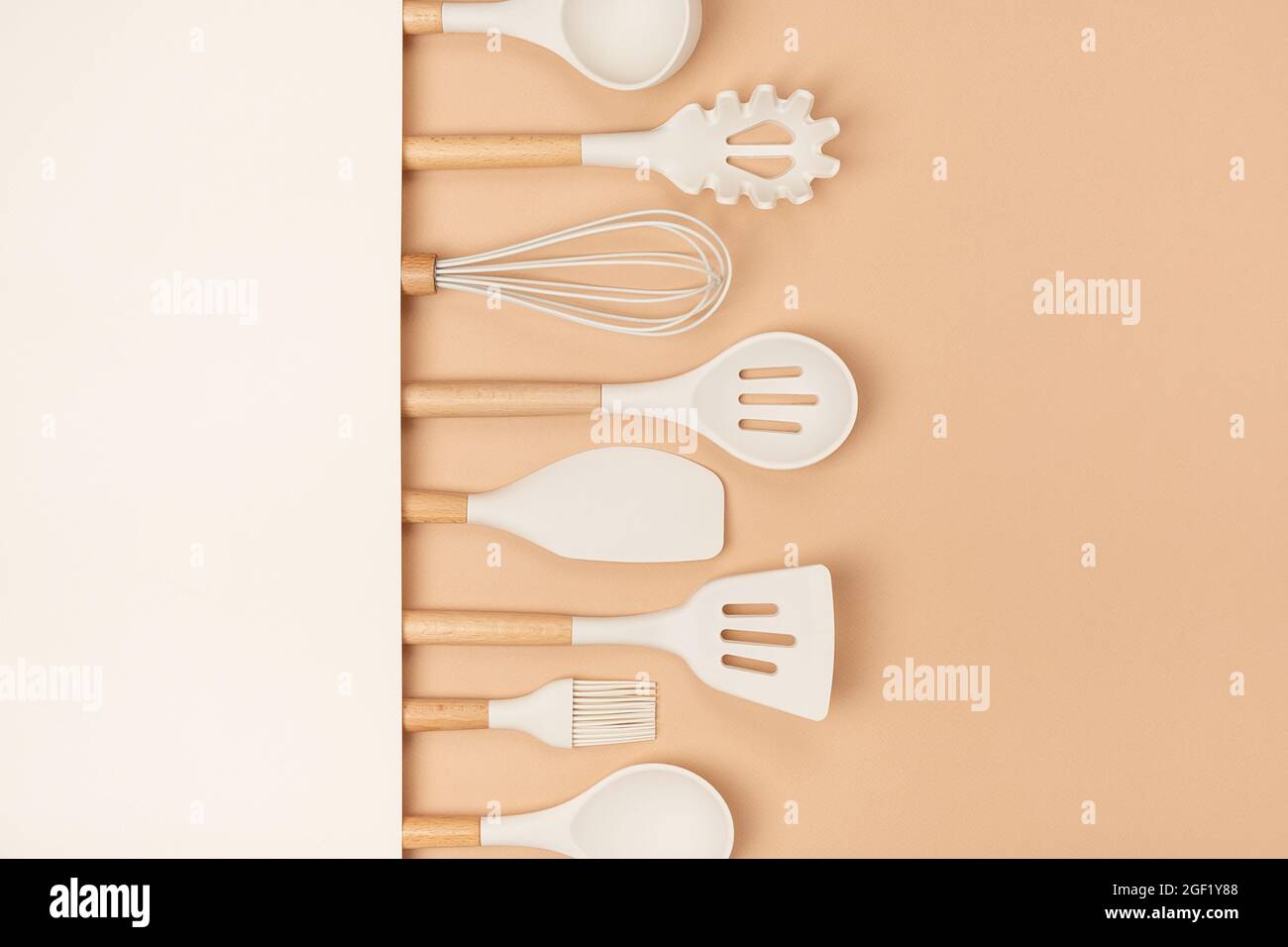 https://c8.alamy.com/comp/2GF1Y88/cooking-utensil-set-silicone-kitchen-tools-with-wooden-handle-on-beige-background-with-copy-space-top-view-flat-lay-2GF1Y88.jpg