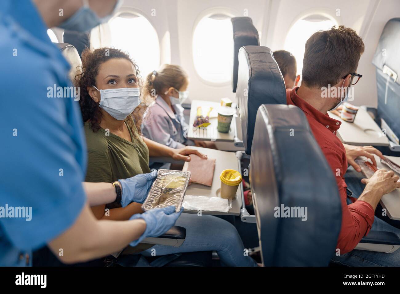 A Passenger Woman on a Airplane Flight Drinking a Bottle of Water Stock  Image - Image of hand, body: 184264045