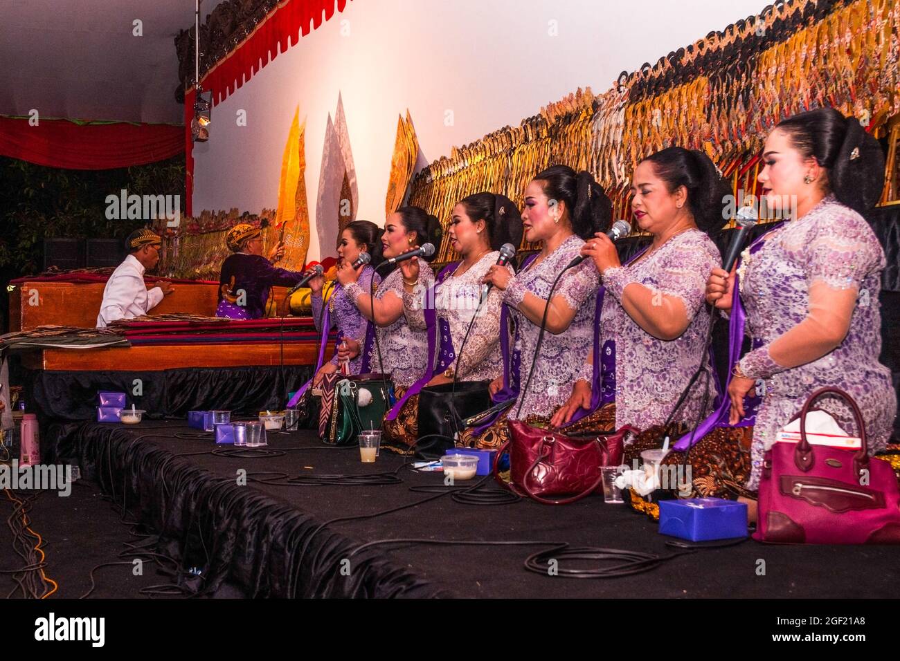 Shadow puppet show, an Indonesian art, especially Javanese. Seen there is a dalang as the main actor accompanied by an assistant and the sindens. Stock Photo