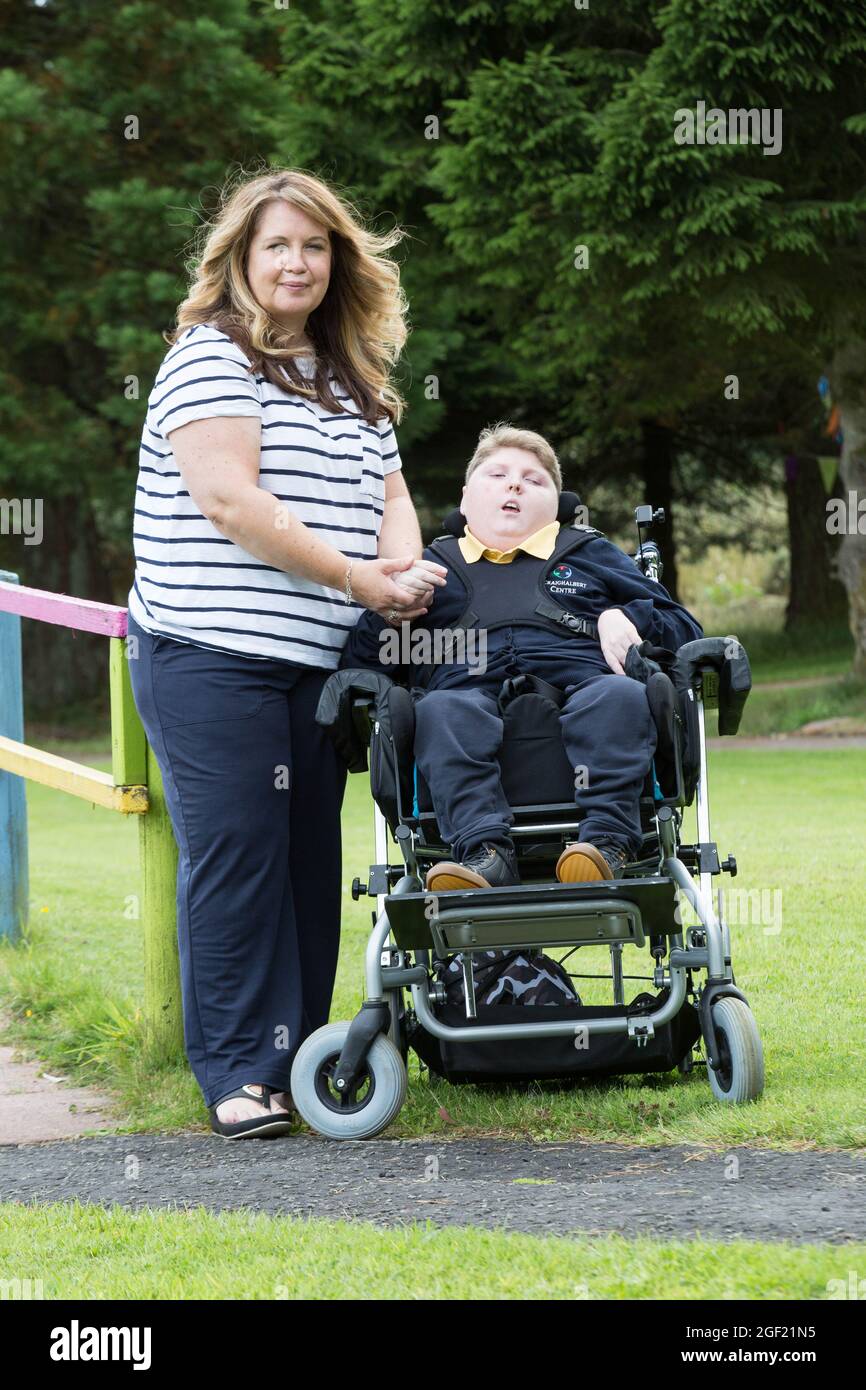 Donna Quinn with her son Logan at Craighalbert Centre, Cumbernauld. The 13 year old has serious respiratory problems and a rare neurological condition and is one of around 4,000 children in Scotland to be offered a Covid-19 vaccine under new guidance. Picture date: Wednesday August 18, 2021. Stock Photo