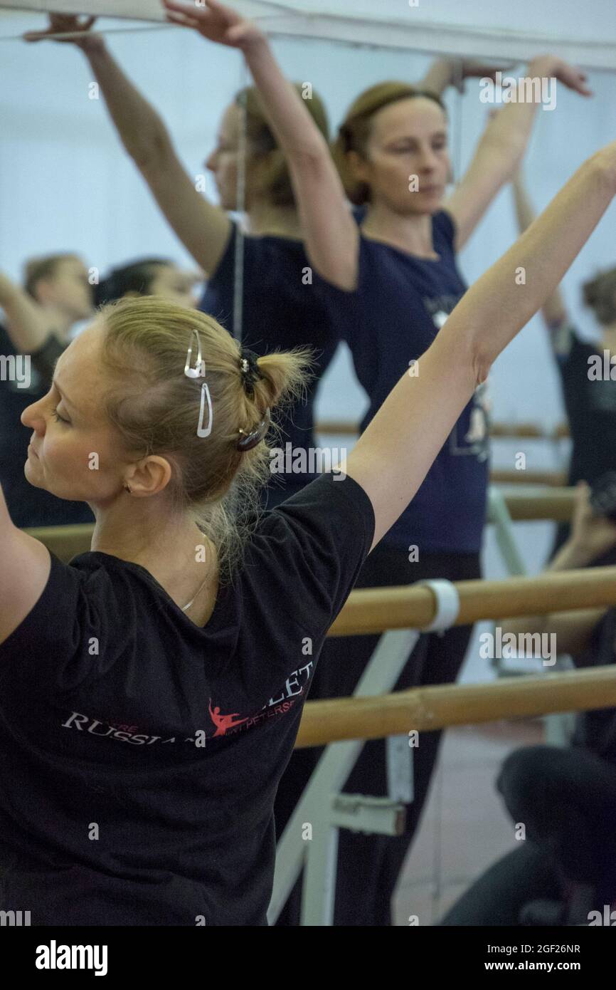 Ballet master instructs a group of ballet dancers in the technique of