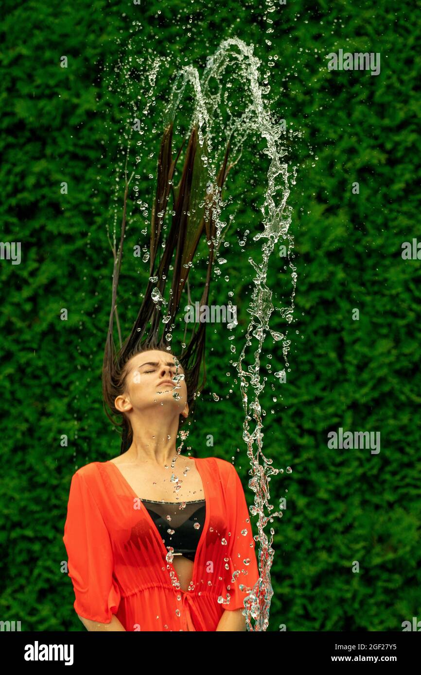 Longhaired girl with wet hair throws her head back Stock Photo Alamy