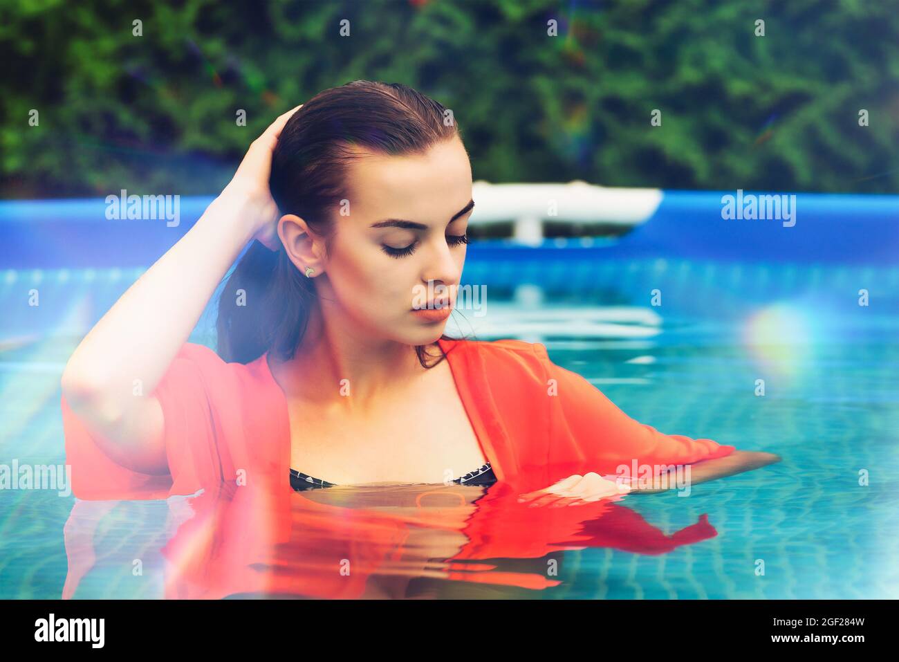 Portrait of a beautiful woman in the swimming pool Stock Photo - Alamy