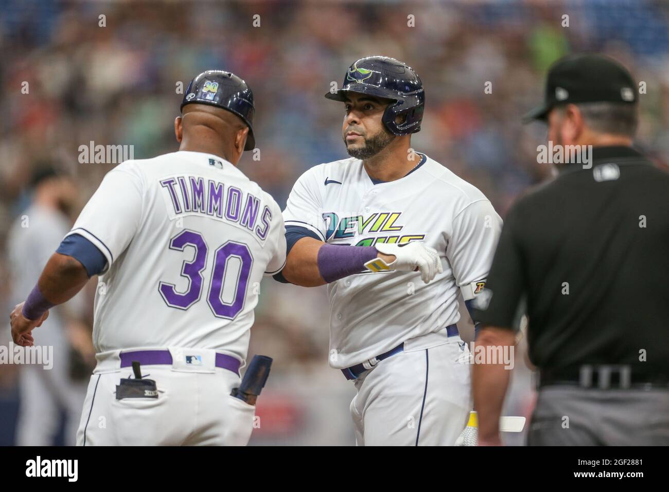 St. Petersburg, FL. USA;  Tampa Bay Rays designated hitter Nelson Cruz (23) is elbow bumped by first base coach Ozzie Timmons after singling in the bo Stock Photo