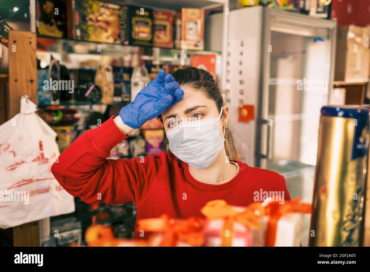 Symptoms of infection. A woman in rubber gloves and a medical mask on ...