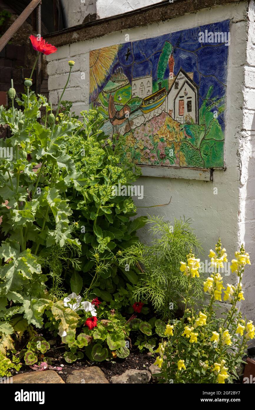 UK Wales, Clwyd, Llangollen, Wharf Hill, ceramic Llangollen Canal scene plaque in garden of canalside cottage Stock Photo