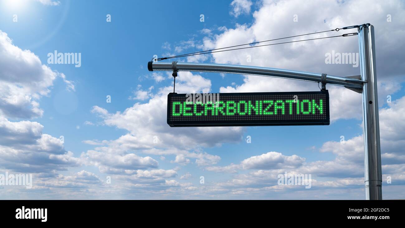 Road information board with text DECARBONIZATION on a background of blue sky. Carbon neutrality concept Stock Photo