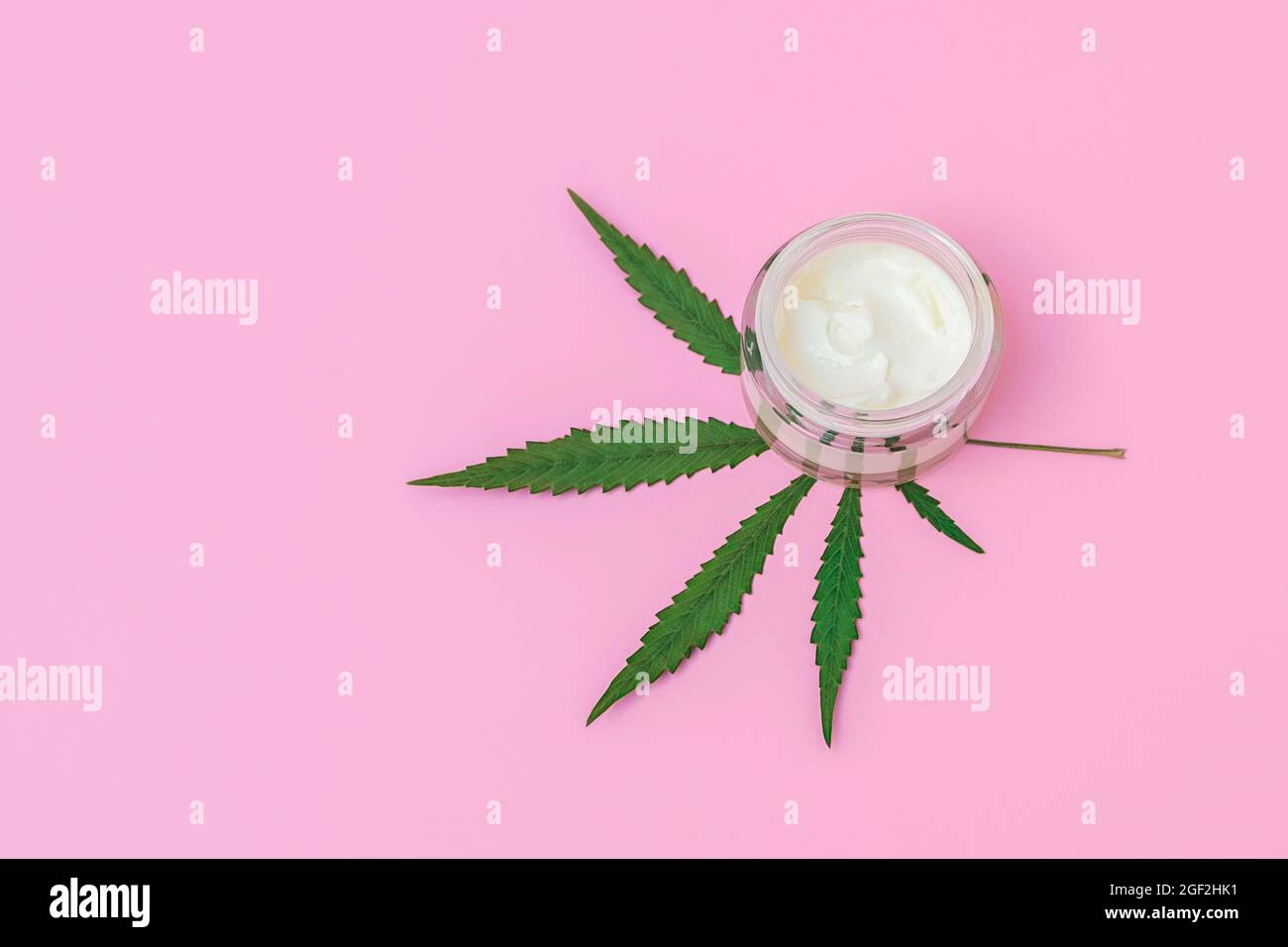 Top view of cosmetic skin care cream with hemp extract on pink background with copy space Stock Photo