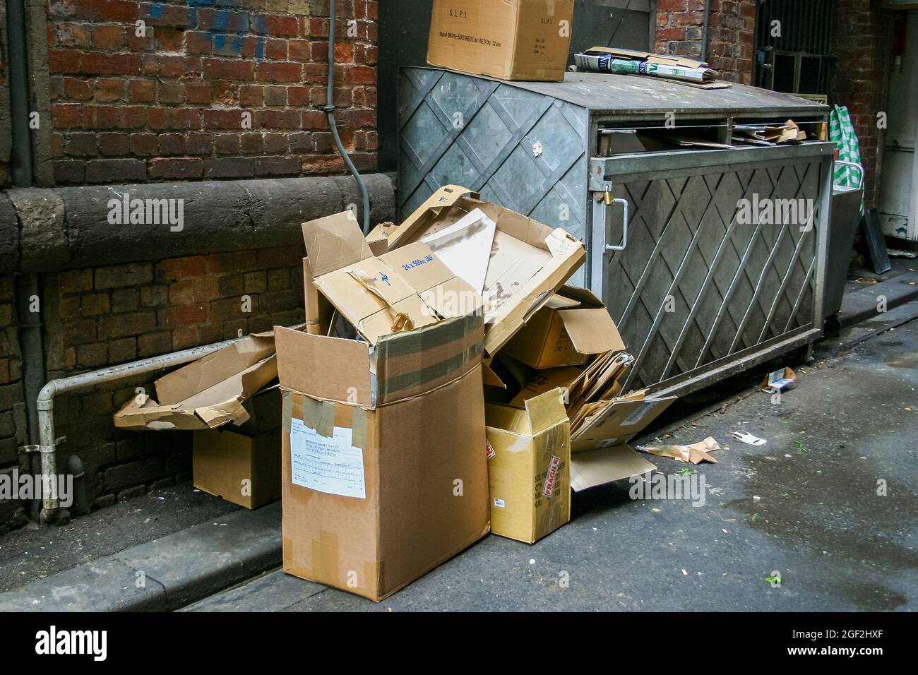 A city laneway filled with boxes and garbage Stock Photo