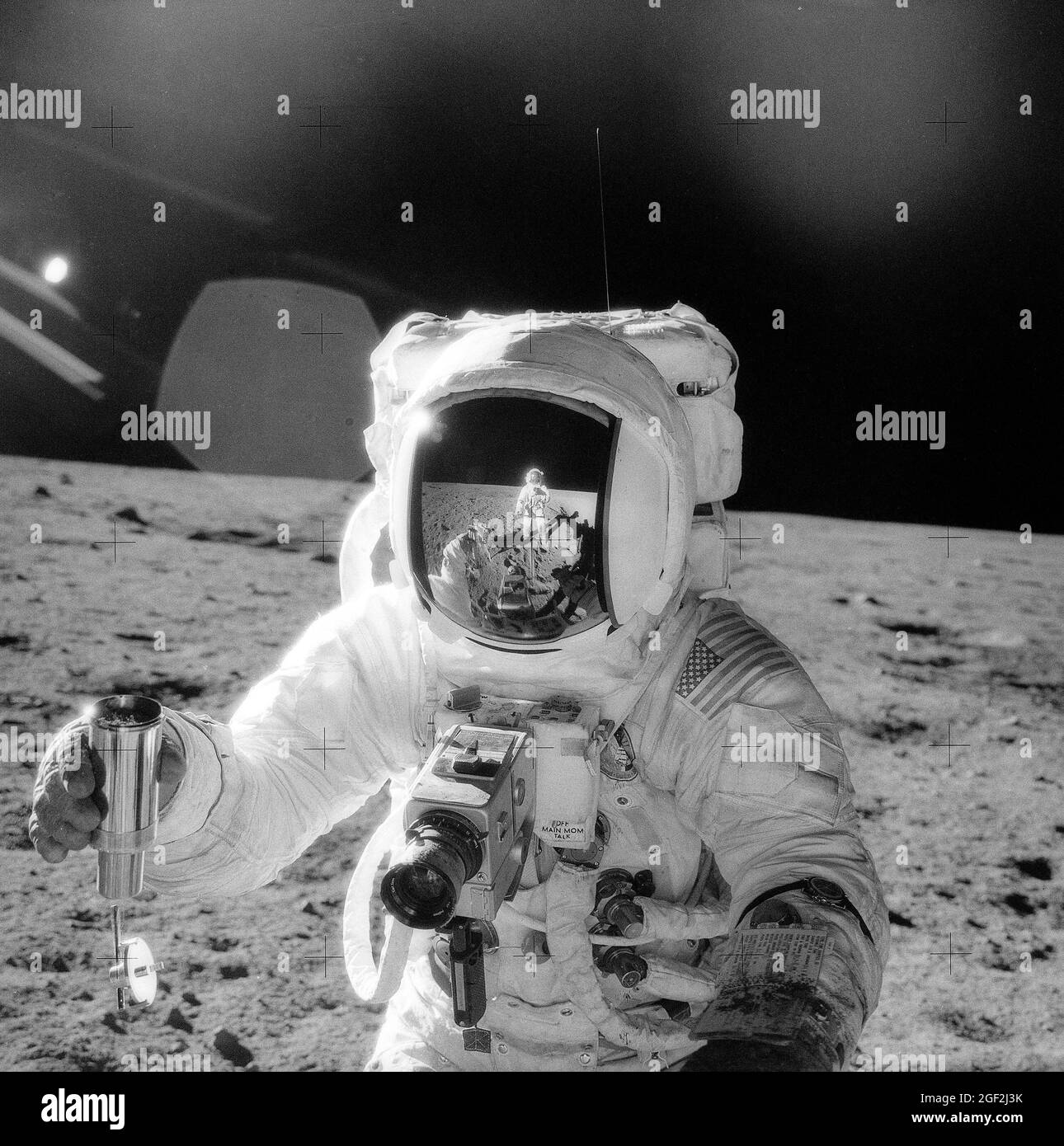 APOLLO 12 ASTRONAUT WITH CONTAINER OF LUNAR SOIL.  REFLECTION OF OTHER ASTRONAUT IN HIS HELMET. 1969-11-20 Stock Photo