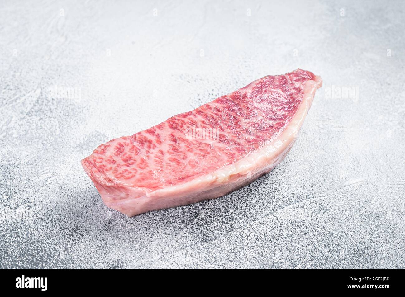 Raw wagyu rump sirloin steak, kobe beef meat. White background. Top ...
