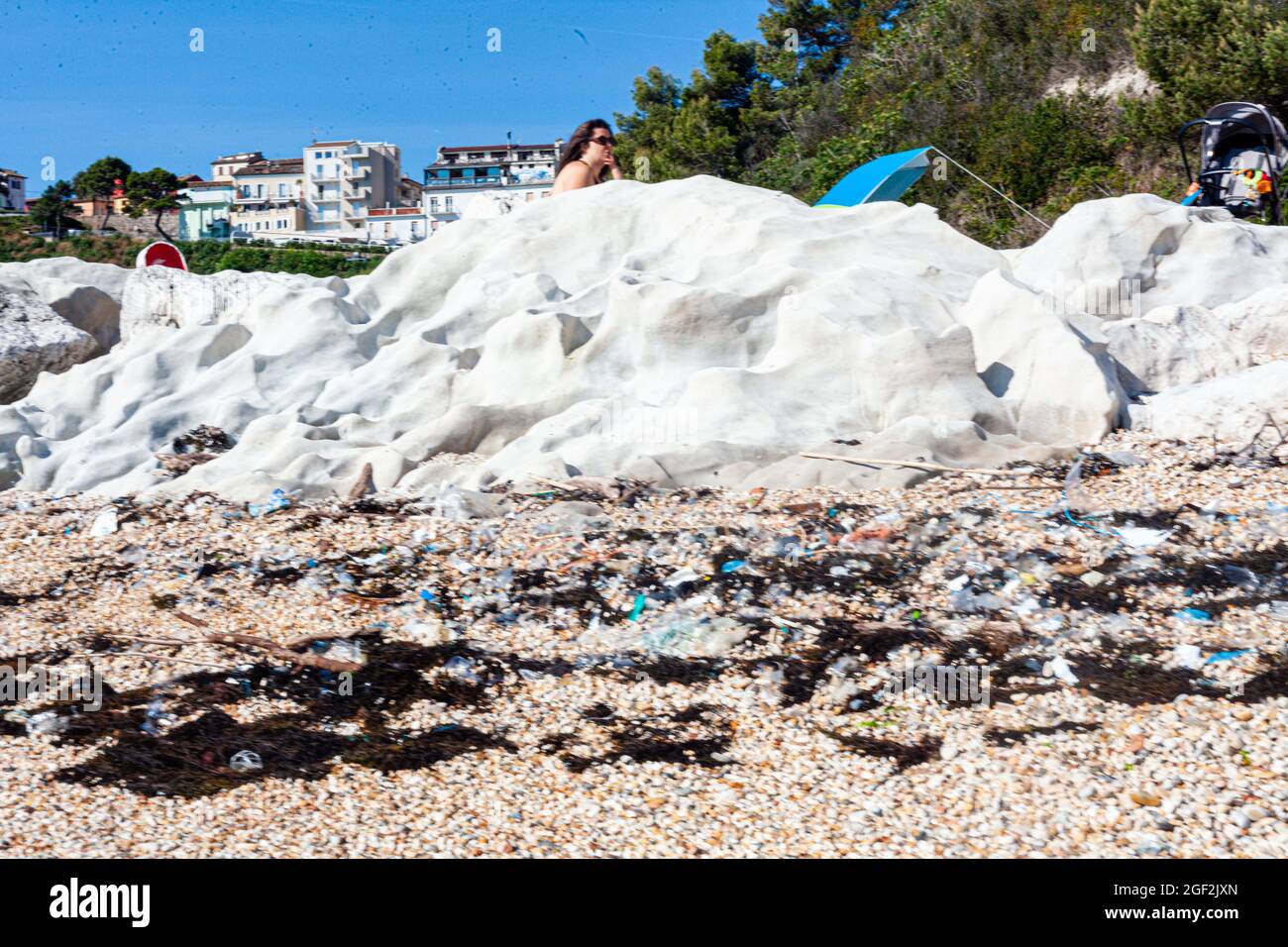 Closeup of plastic waste on the rocks of a beach in Numana, Italy Stock ...